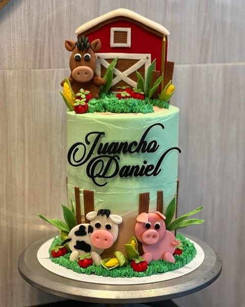 Birthday cake with a farm animal red barn theme