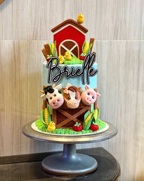 Birthday cake with a farm cow goat sheep theme