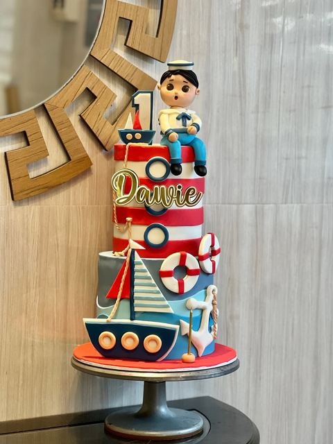 Birthday cake with a sailor sailing boat theme