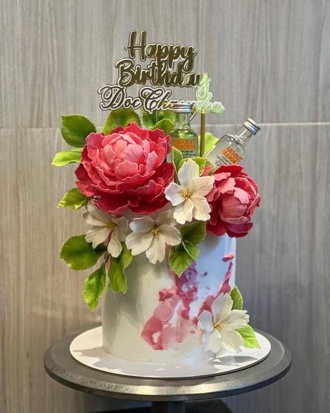 Birthday cake with a floral pink and white theme