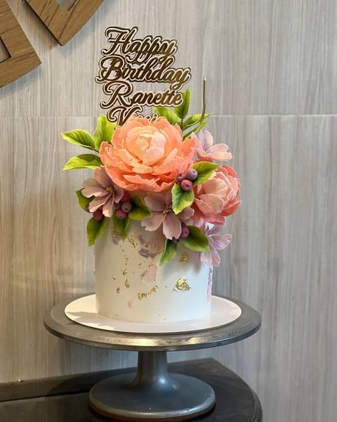 Birthday cake with a floral rainbow theme