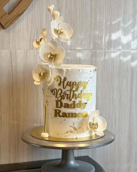 Birthday cake with a white orchid and gold theme