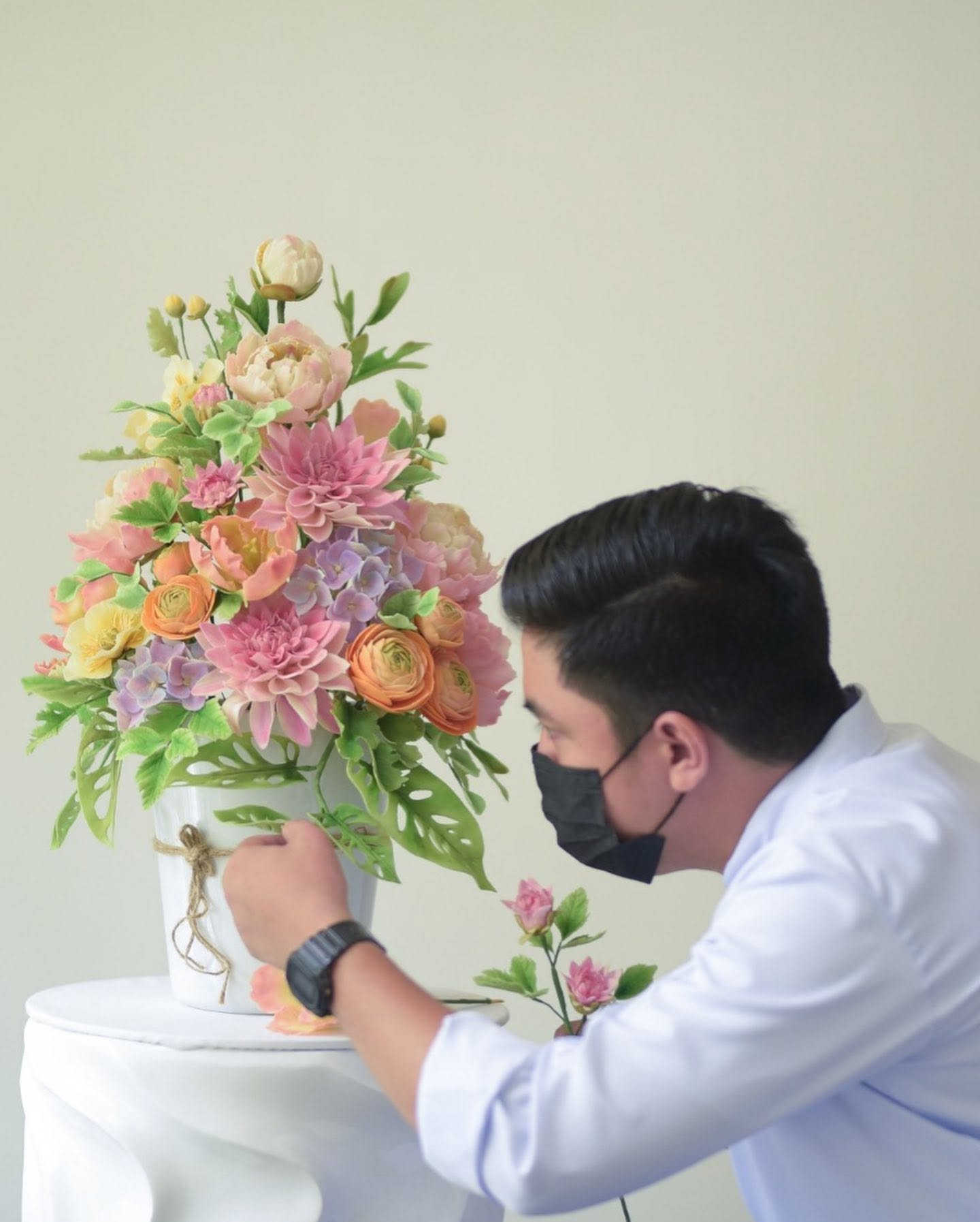 Jairuz Bon Bermudez Edaño hand-shaping sugar flowers for the award-winning arrangement